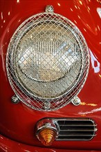 Round headlamp with grille as protection against stone chipping Glass breakage on historic classic sports car racing car classic car Porsche 356 2000 GT, Techno Classica trade fair