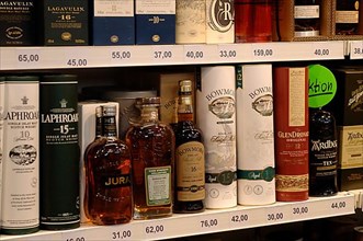 Various whisky bottles on the sales shelf in a supermarket,