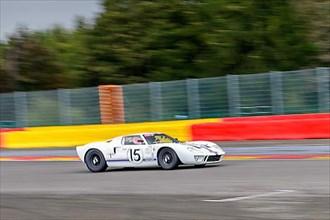 Photo of historic racing car Ford GT40 on Spa Francorchamps race track in curve 1 La Source, Ardennes roller coaster