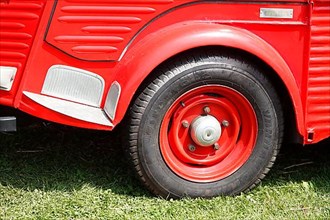 Car tyres on a vintage car, red Citroen van