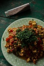 Vegan scrambled eggs with smoked tofu, chives and salt