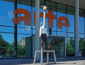 Artwork Giraffe Man by Stephan Balkenhol, in front of the building of the TV station Arte