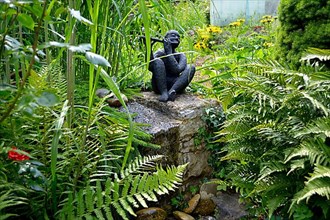 Black Garden Figurine with Flute by the Garden Stream