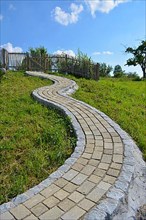 Beautifully curved cobblestone path to the garden