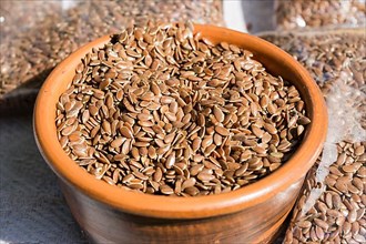 Flax seeds in a clay bowl close-up