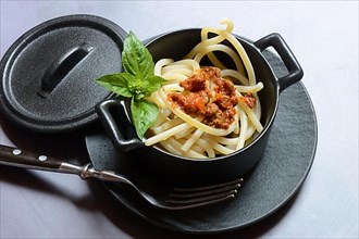 Pici pasta with Bolognese sauce in pots