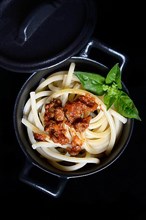 Pici pasta with Bolognese sauce in pots