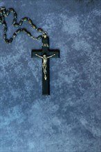 Crucifix and rosary on a dark background