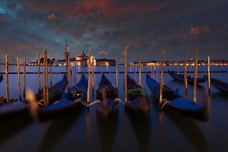 Gondolas in front of the Piazzetta on the lagoon at St. Mark's Square blue hour in front of sunrise