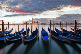 Gondolas in front of the Piazzetta on the lagoon at St Mark's Square at sunrise