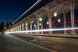 Long exposure of the Pont de Bir Hakeim with light trail of a passing vehicle