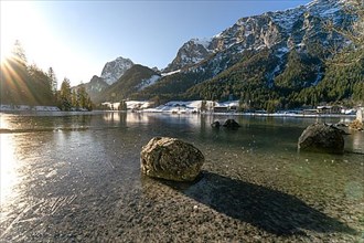 Round boulder in Hintersee at sunset in winter landscape