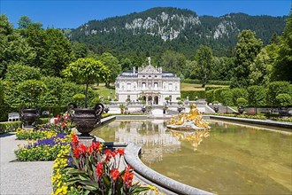 Linderhof Palace with fountain and blossoming flowers