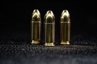 Three gun shells of a gun on a black background