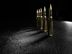 Five gun shells of a gun on a black background