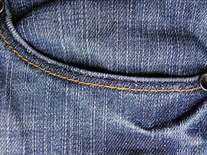Denim jeans as blue background. With trouser pocket shown in full image in the plane