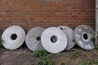 Discarded millstones on a clinker wall