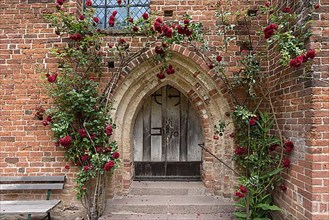 Rose-covered entrance portal of the Gothic village church