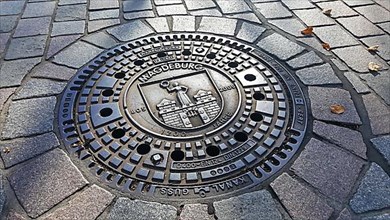 Manhole cover of Magdeburg with coat of arms of the city