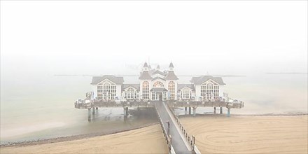 Sellin pier on the Baltic Sea island of Ruegen at fog