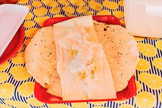 Traditional Nicaraguan Quesillo served on a plate on the table. Top view of Nicaraguan Quesillo served on table. Latin American food Quesillo
