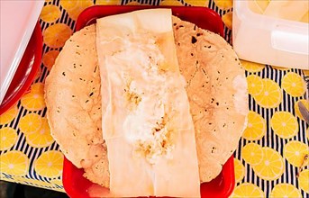 Top view of Nicaraguan Quesillo served on table. Traditional Nicaraguan Quesillo served on a plate on the table. Latin American food Quesillo
