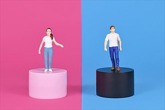 Concept for pink and blue gender stereotypes with man and woman figure on different colored backgrounds