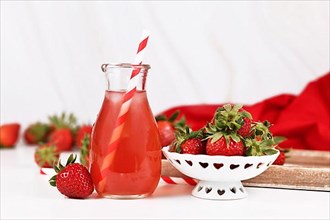 Red strawberry fruit lemonade in jar with raw berries