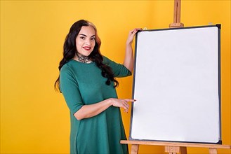 Beautiful woman near a blank whiteboard