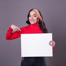 Beautiful woman pointing at a blank whiteboard