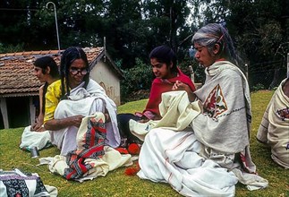 Toda ladies engage in embroidery work on their traditional costume the poothukuli in Ooty Udhagamandalam