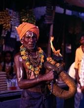 A devotee holding fire torch