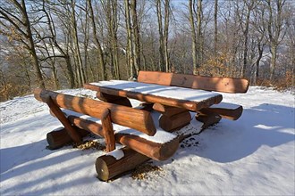 D. BW. Wooden bench with snow and hoarfrost at the Aschberg between Oelbronn and Maulbronn. Deciduous forest with hoarfrost in winter