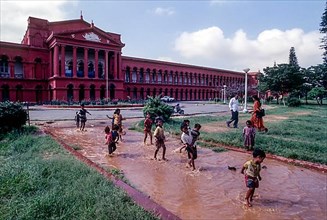 Children playing the rain water in front of High Court in Bengaluru Bangalore