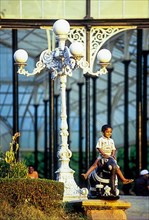 A boy playing in front of glass house at Lal Bagh botanical gardens in Bengaluru Bangalore