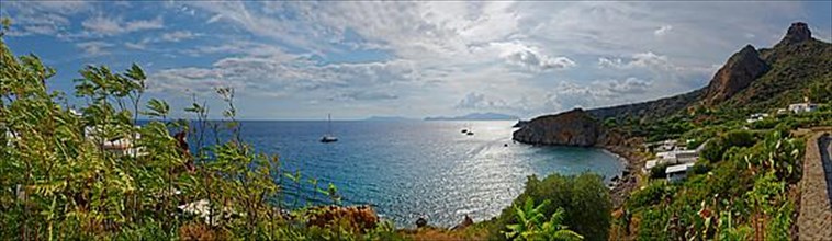 Panoramic view of Isola di Basiluzzo and Vulcano with anchored sailing ships