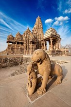 King and lion fight statue and Kandariya Mahadev temple. Khajuraho