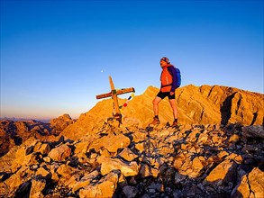 Mountaineers on the summit of the Kleiner Watzmann in the morning light