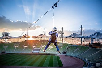 Woman at a zip line above the Olympic Stadium