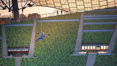 Woman swinging on a zip line above the Olympic Stadium