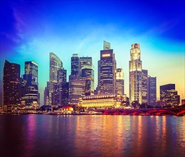 Vintage retro hipster style travel image of Singapore skyline and river in evening