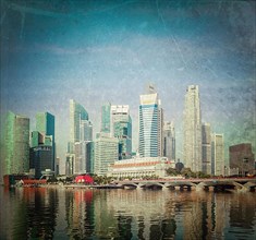 Vintage retro hipster style travel image of Singapore business district skyscrapers and Marina Bay in day