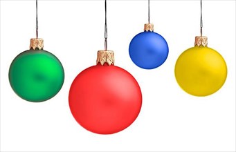 Several hanging Christmas baubles isolated on white background