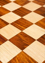 Wooden chess board with brown and yellow squares background