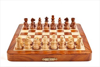 Wooden chess on chessboard ready to play