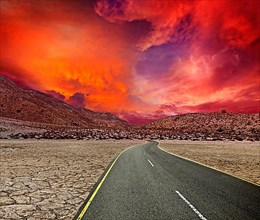 Road in desert on sunset