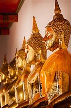 Sitting Buddha statues close up. Wat Pho temple