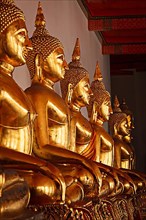 Row of golded sitting Buddha statues in Buddhist temple Wat Pho