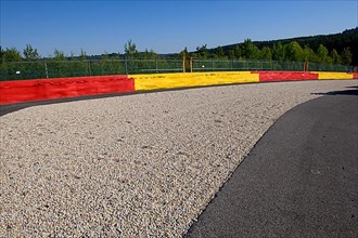 Safety measure for car racing Gravel bed behind Protection from impact from covered tyre piles next to race track for motorsport