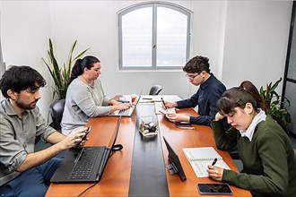 People working on laptops during a meeting